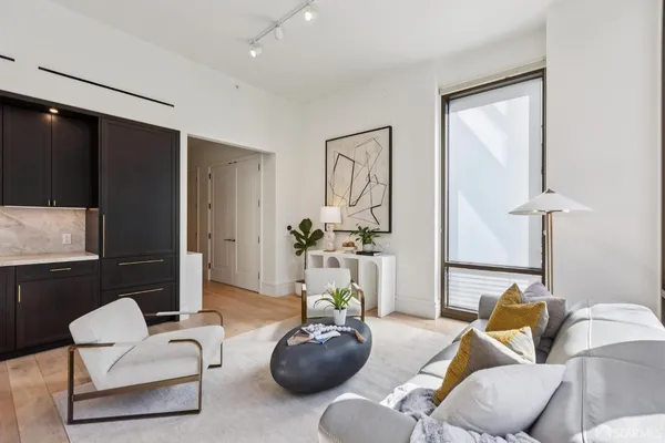 a living room with furniture and a wooden floor