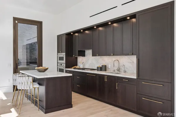 a kitchen with a stove a sink and a refrigerator