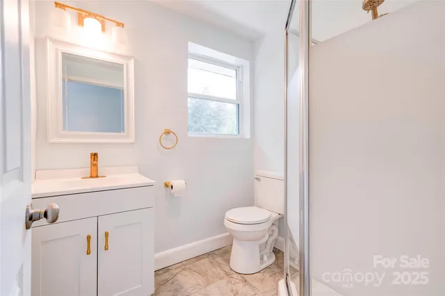 a bathroom with a sink toilet and a mirror