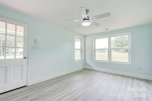 wooden floor in an empty room with a window