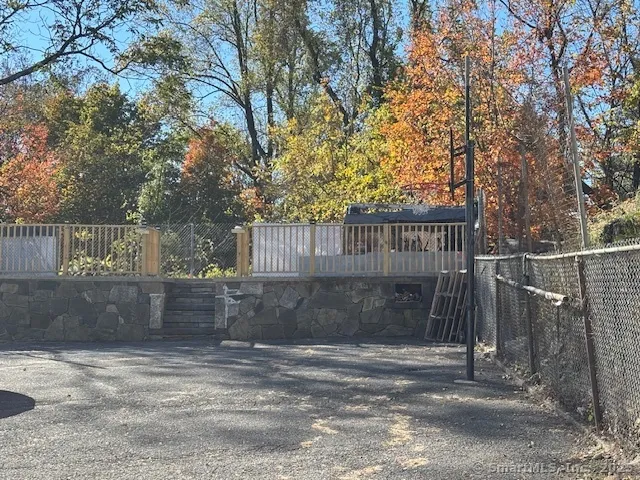 a view of a street with large trees