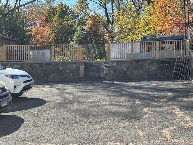 a view of a backyard with a fence and wooden fence