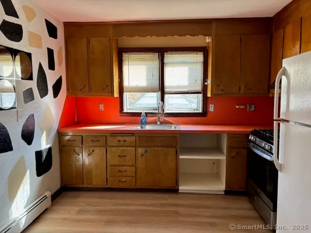 a kitchen with stainless steel appliances granite countertop a sink and a refrigerator
