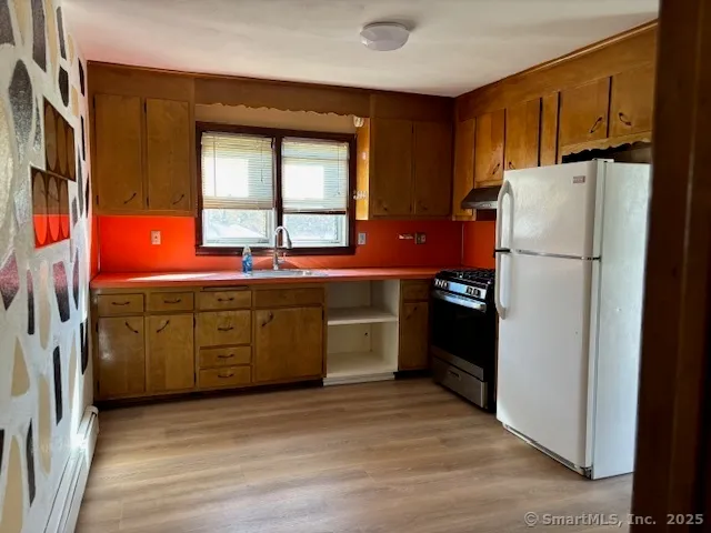 a kitchen with stainless steel appliances a refrigerator sink and cabinets