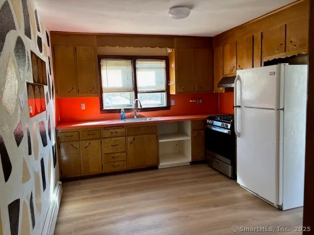 a kitchen with stainless steel appliances a refrigerator sink and cabinets