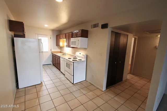 a kitchen with stainless steel appliances a refrigerator and a stove