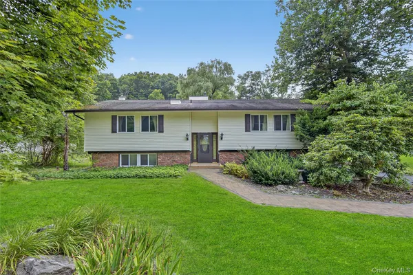 a view of an house with backyard space and garden