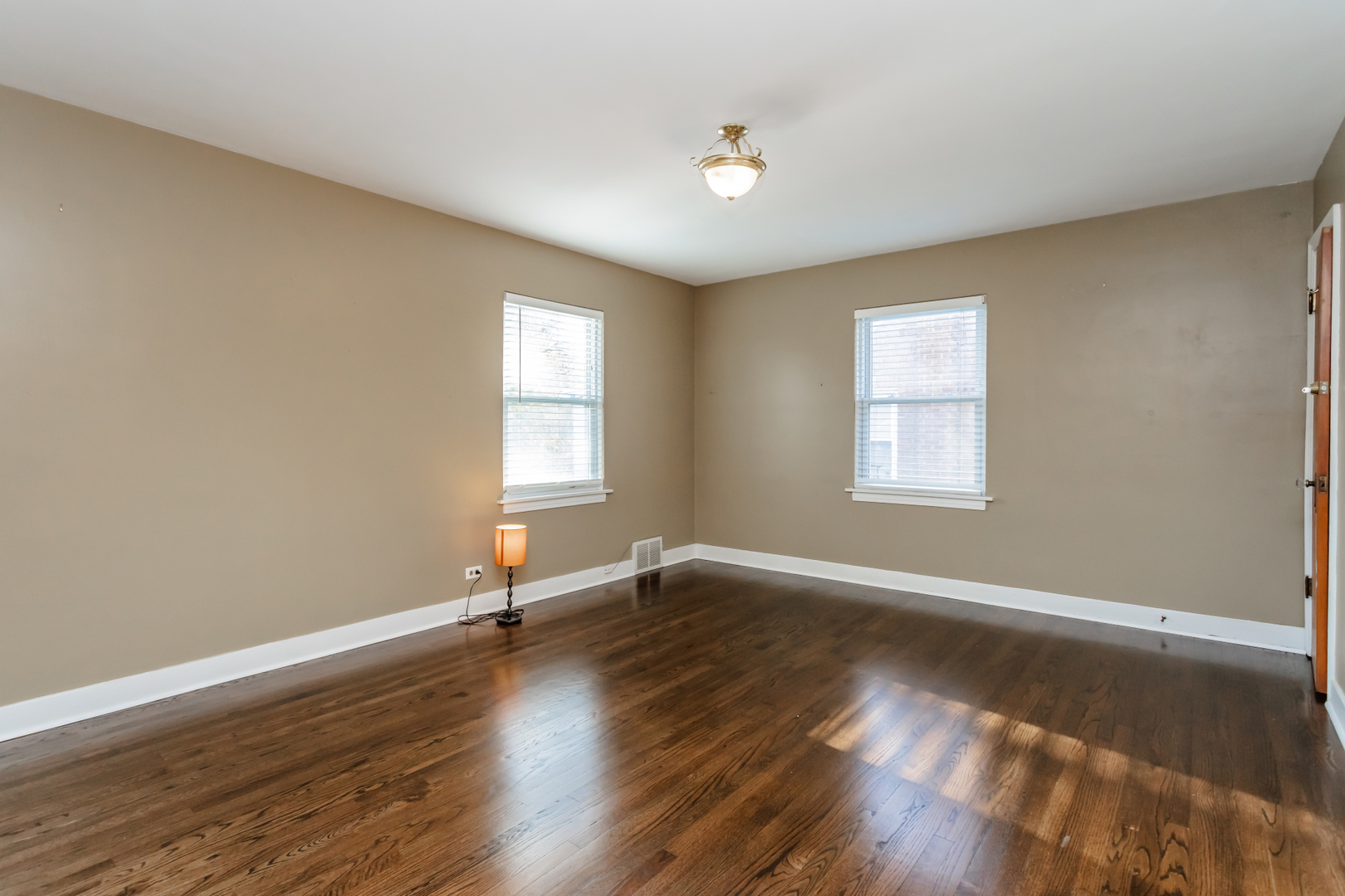 552 East Parkway Road Riverside, IL 60546 - Photo 13 of 25 an empty room with wooden floor and windows