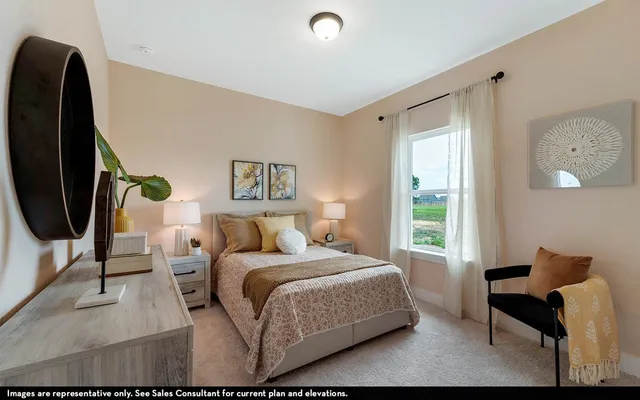 a bedroom with a bed chair and a window