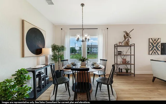a dining room with furniture a chandelier and wooden floor