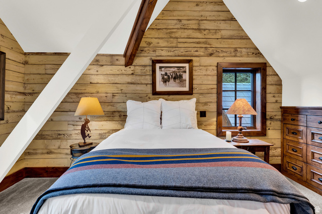 2983 East Ridgetop Road, Unit 27 Provo, UT 84604 - Photo 38 of 63 Charming bedroom retreat showcasing rustic wood plank walls, vaulted ceilings with exposed beam detailing, and abundant natural light from dual windows