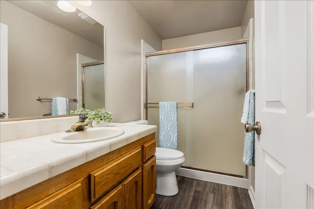 a bathroom with a sink a toilet and shower