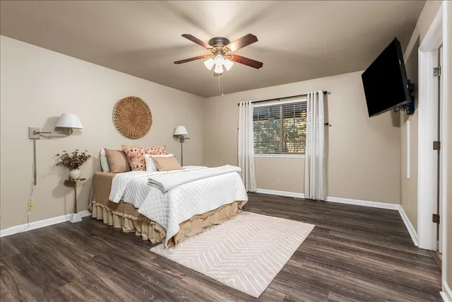 a bedroom with a large bed mirror and window