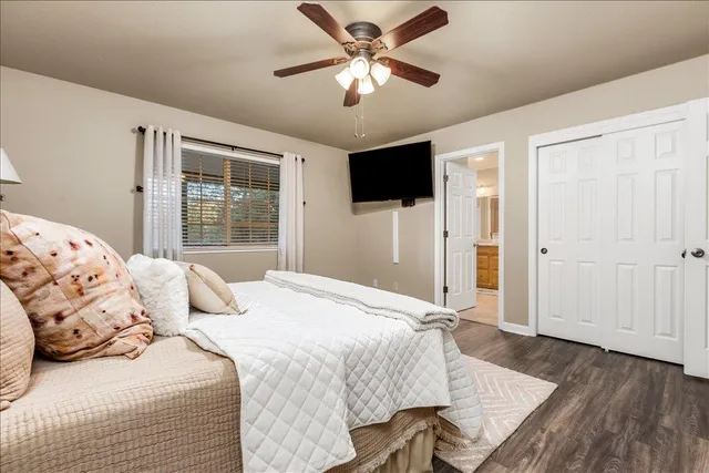 a bedroom with a bed and a flat screen tv