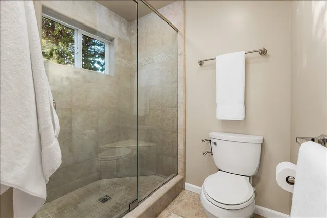 a white toilet sitting next to a bathroom sink