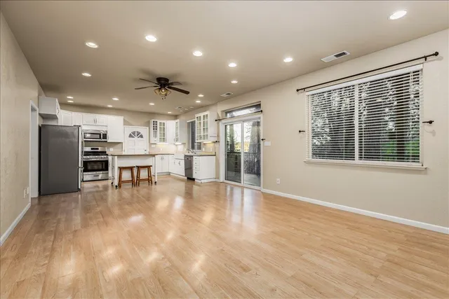 a view of kitchen with stainless steel appliances refrigerator oven and cabinets