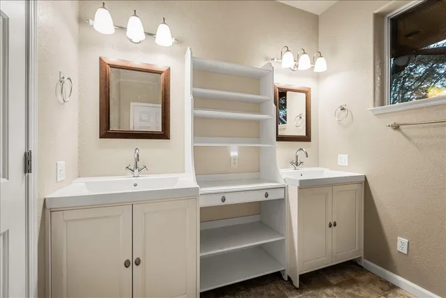 a bathroom with a sink vanity and mirror