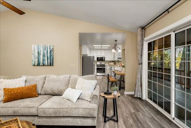 a living room with furniture a flat screen tv and next to a window
