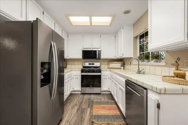 a kitchen with a refrigerator stove and sink