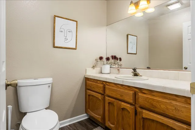 a bathroom with a toilet a sink and mirror