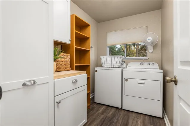 a view of washer and dryer with wooden floor