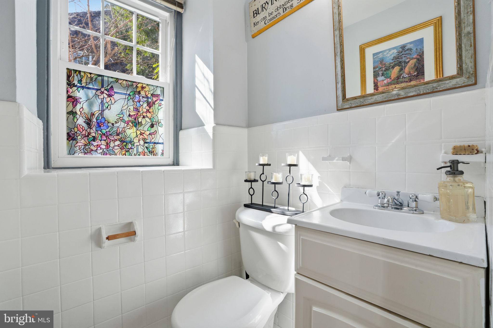7791 Spring Avenue Elkins Park, PA 19027 - Photo 13 of 33 a bathroom with a toilet sink and mirror