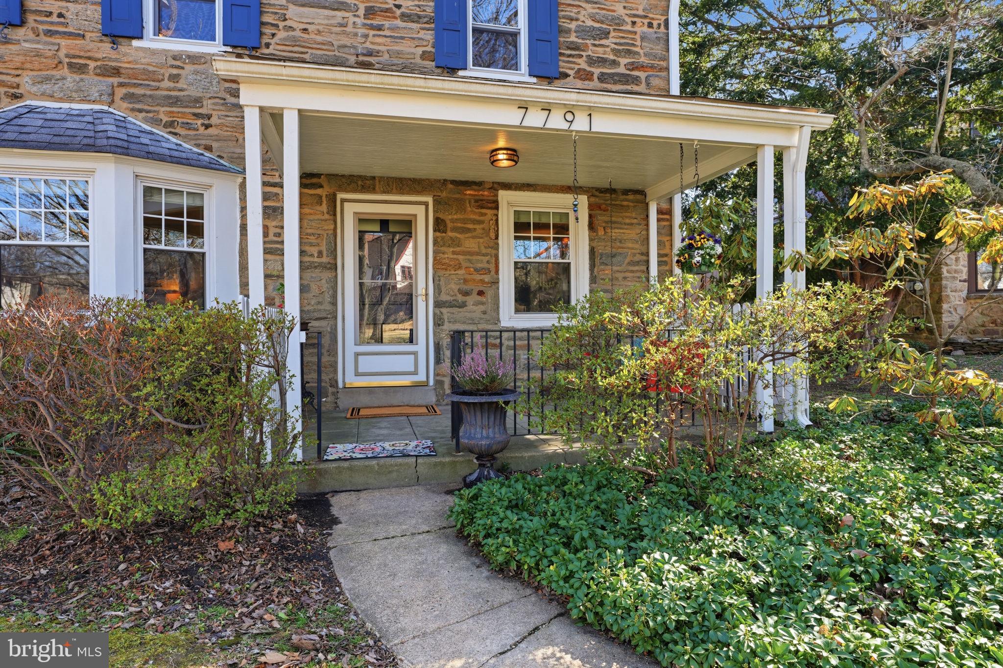 7791 Spring Avenue Elkins Park, PA 19027 - Photo 2 of 33 front view of a brick house with potted plants