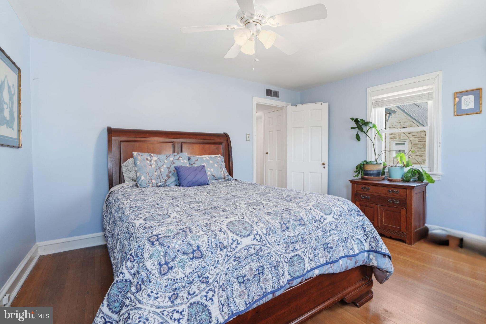 7791 Spring Avenue Elkins Park, PA 19027 - Photo 21 of 33 a bedroom with a bed table and a potted plant