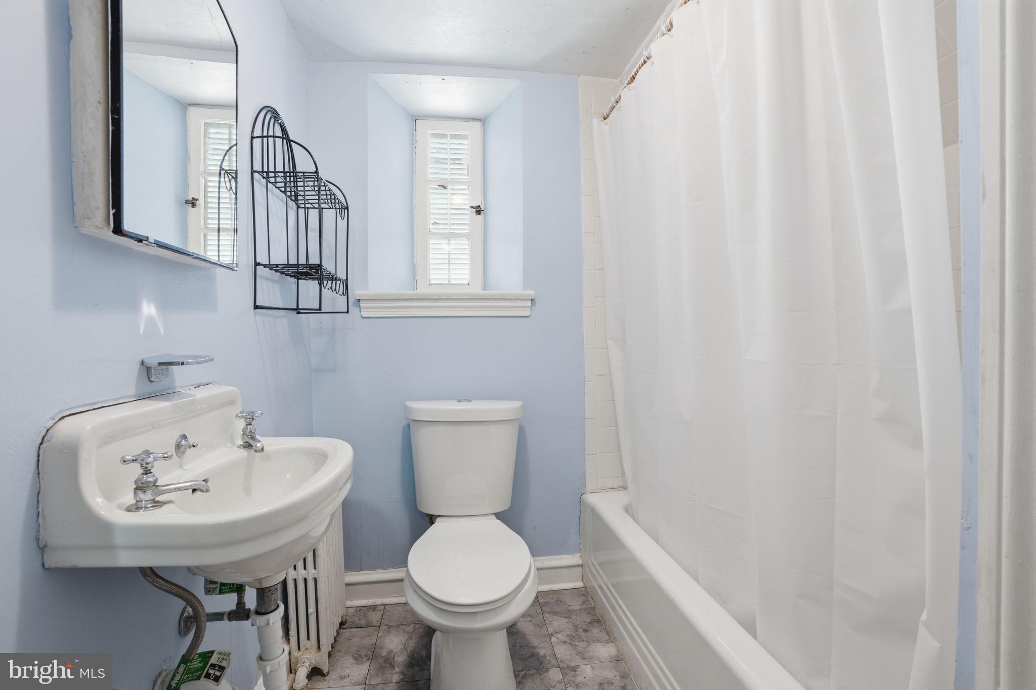 7791 Spring Avenue Elkins Park, PA 19027 - Photo 23 of 33 a bathroom with a sink a toilet and a mirror