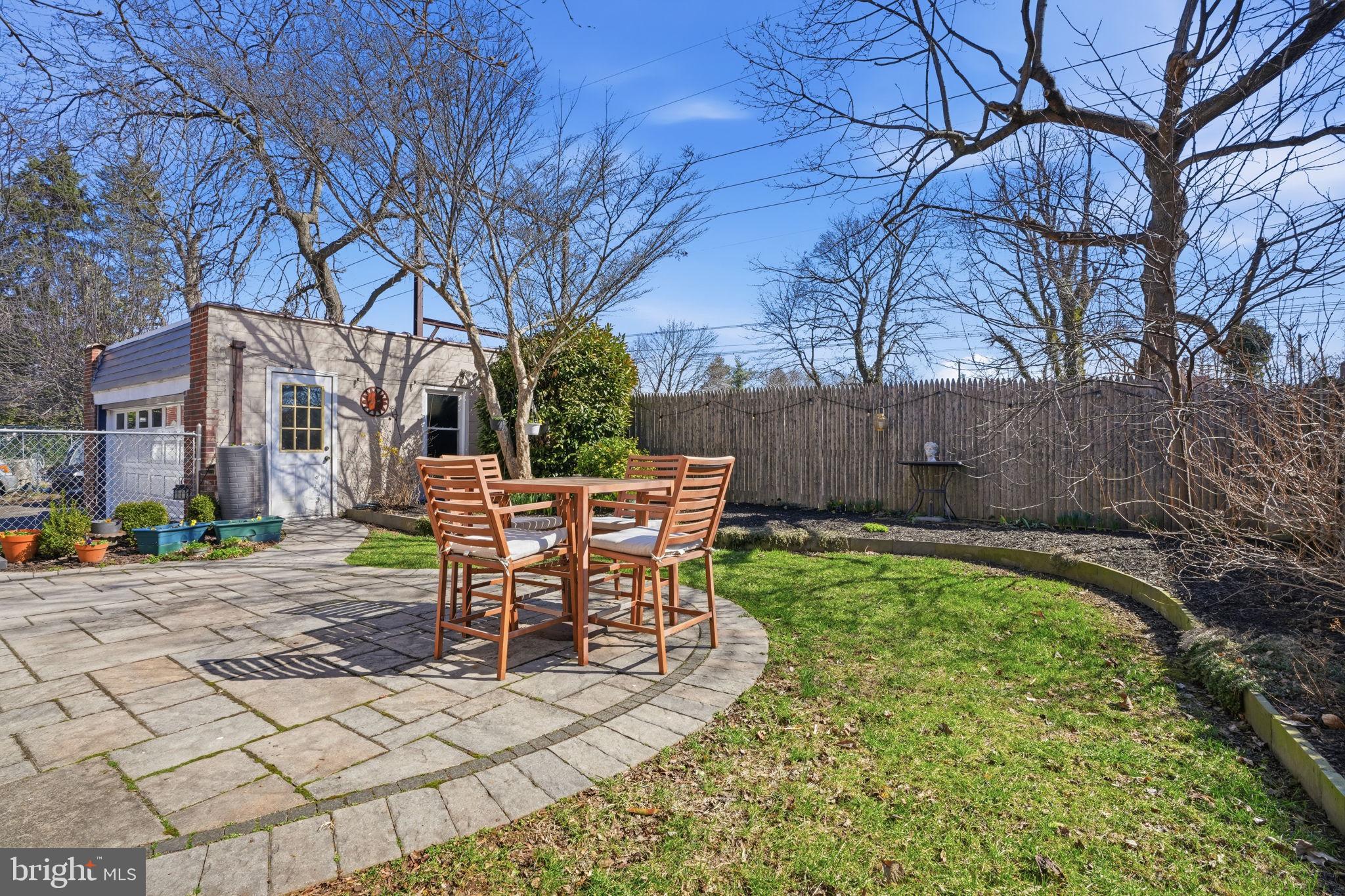 7791 Spring Avenue Elkins Park, PA 19027 - Photo 27 of 33 a view of a patio with table and chairs with wooden fence and plants