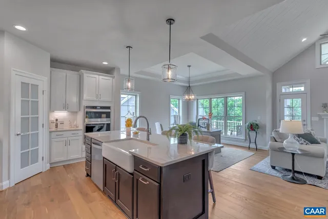a kitchen with sink cabinets and living room view