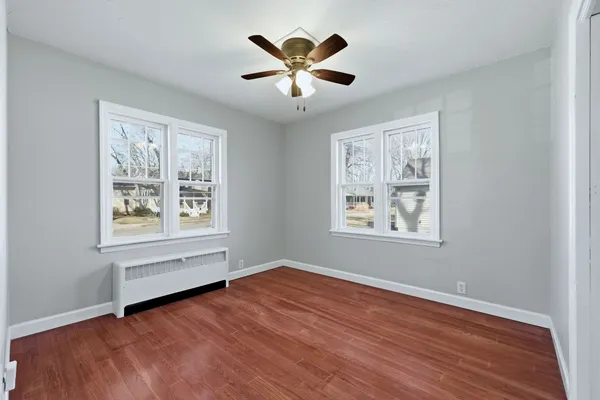 a view of room with window and ceiling fan