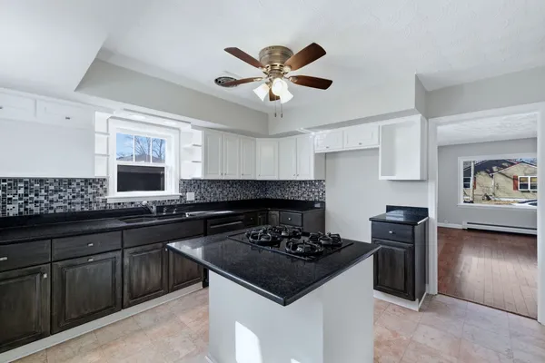 a kitchen with a stove a sink and a refrigerator