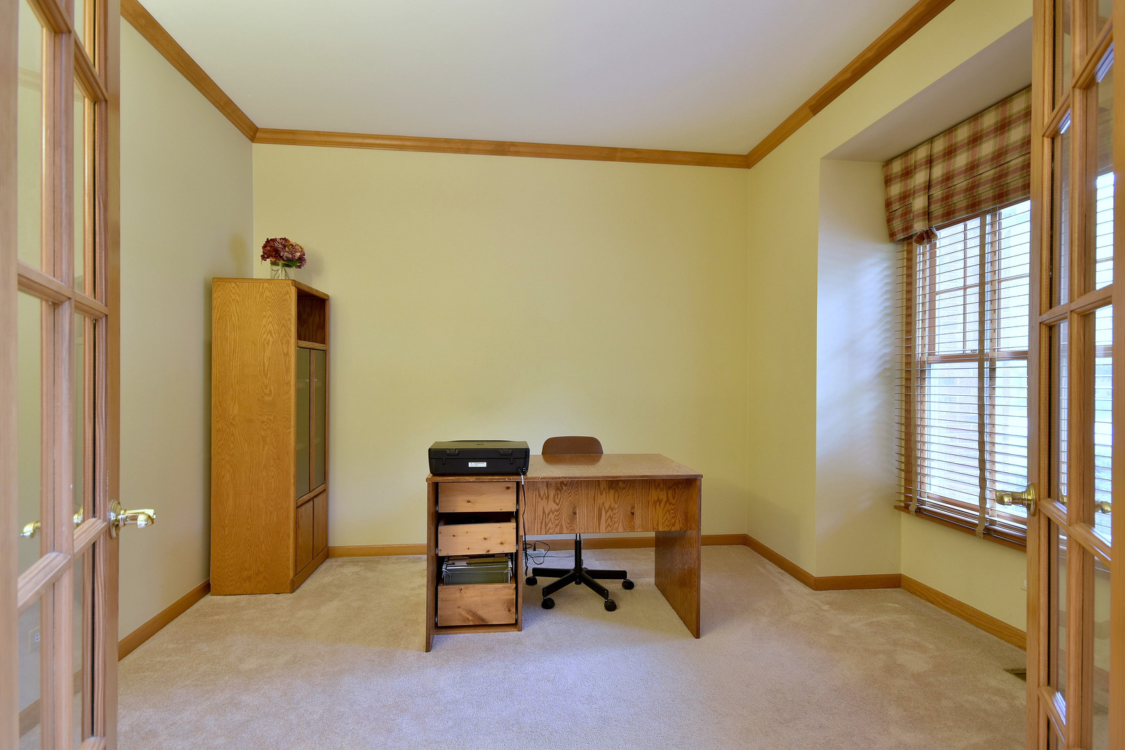 448 Lewis Road Geneva, IL 60134 - Photo 17 of 52 a view of a workspace with furniture and a window