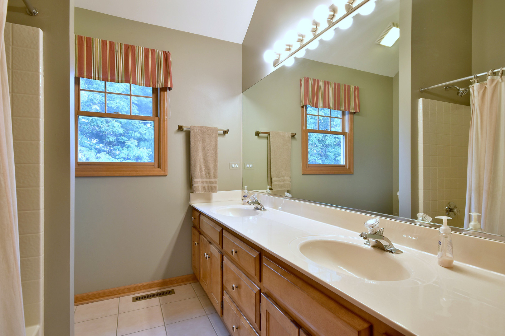 448 Lewis Road Geneva, IL 60134 - Photo 33 of 52 a bathroom with a double vanity sink and a mirror