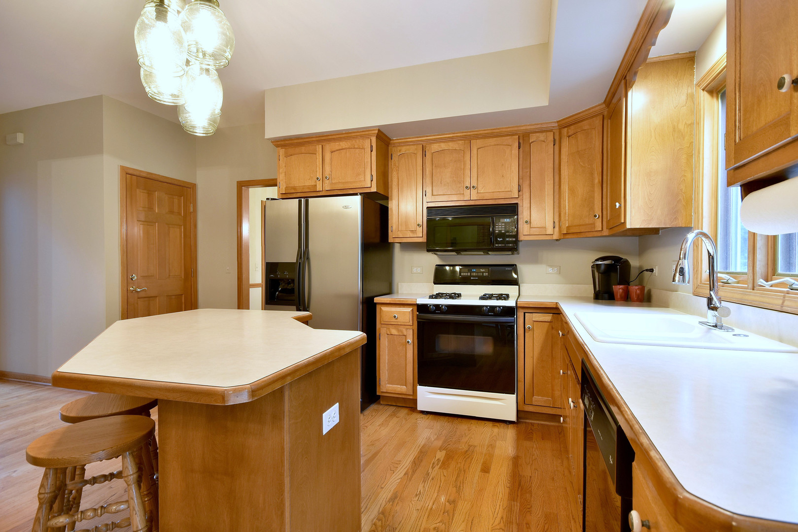 448 Lewis Road Geneva, IL 60134 - Photo 6 of 52 a kitchen with stainless steel appliances a stove refrigerator sink and microwave
