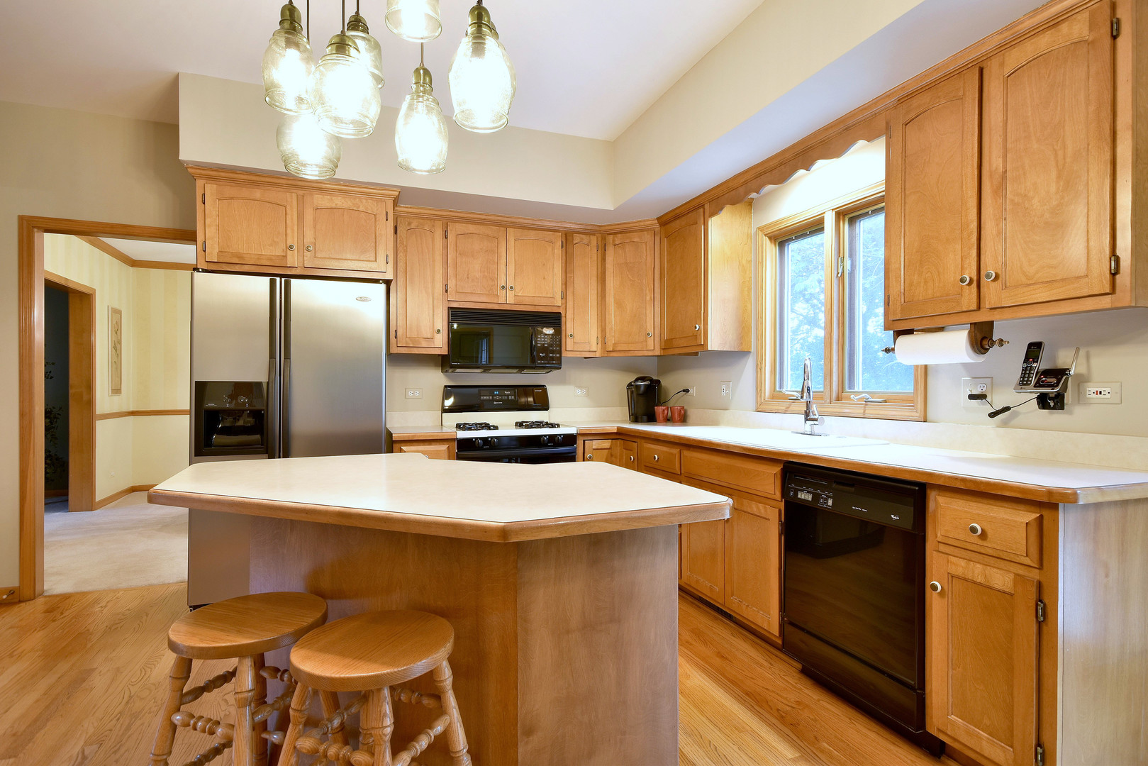 448 Lewis Road Geneva, IL 60134 - Photo 7 of 52 a kitchen with a stove a sink and a refrigerator