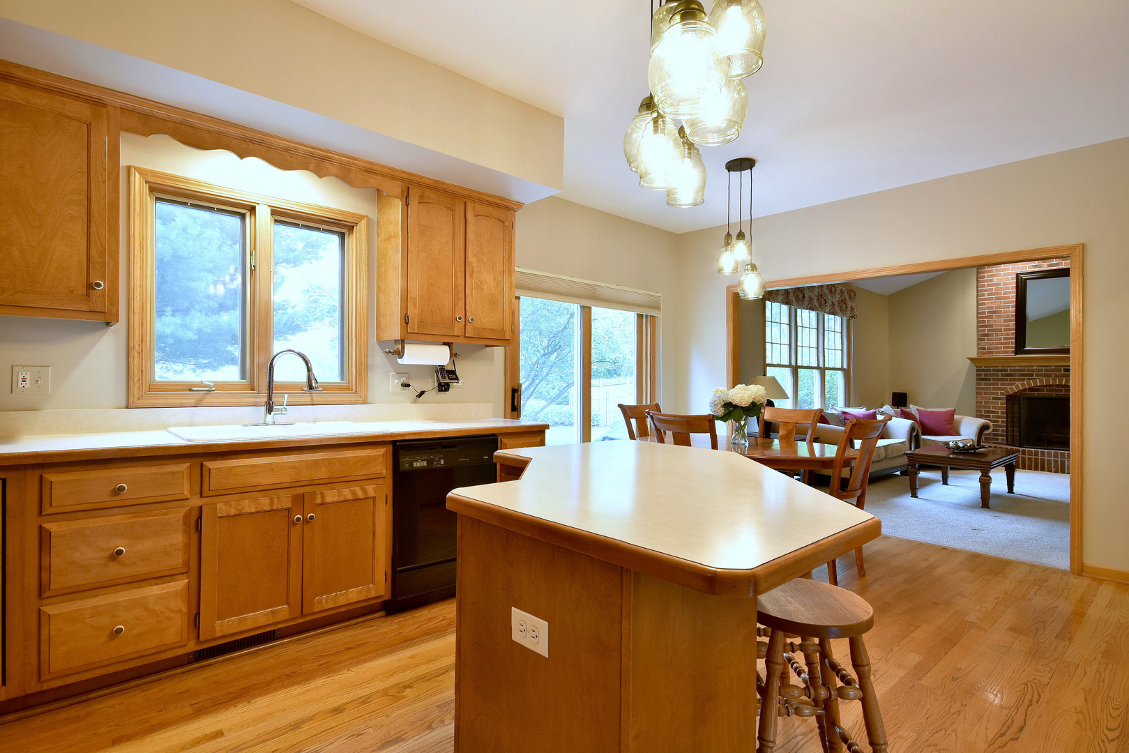 448 Lewis Road Geneva, IL 60134 - Photo 8 of 52 a large kitchen with kitchen island a counter space a sink a dining table and chairs