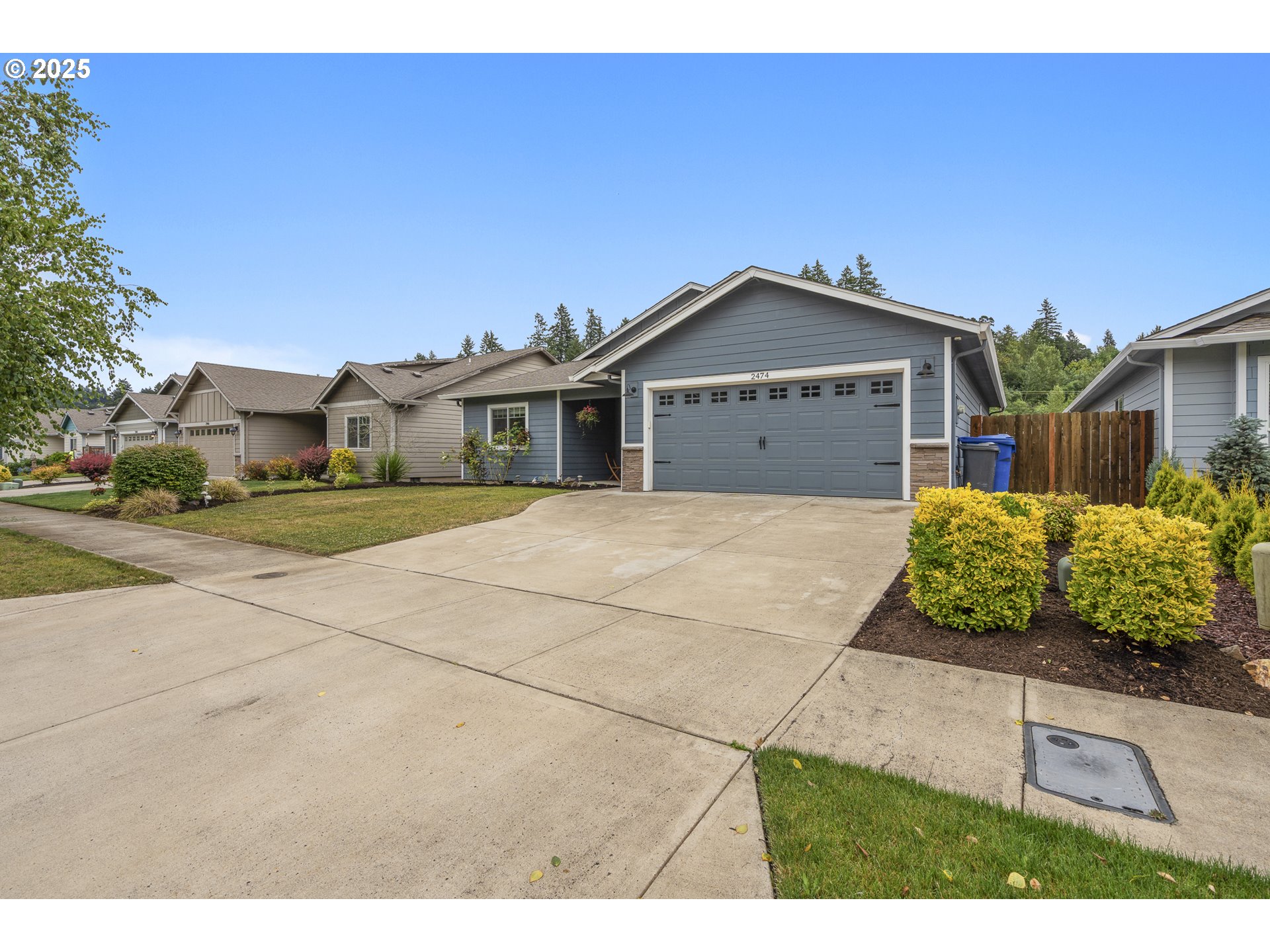 2474 Equestrian Loop South Salem, OR 97302 - Photo 2 of 23 a front view of a house with a garden and yard