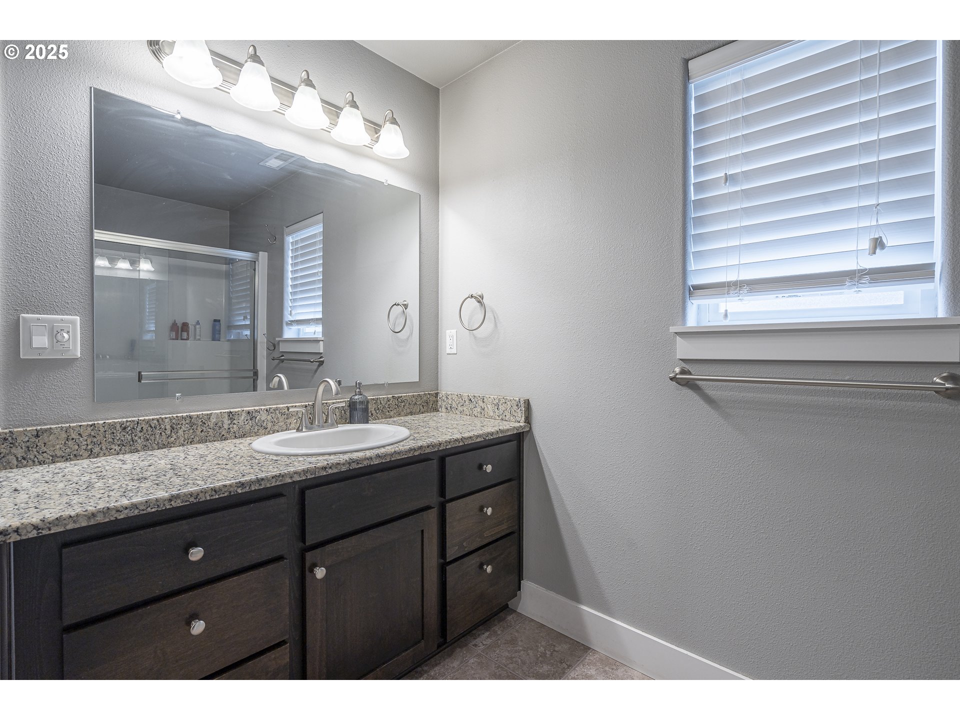 2474 Equestrian Loop South Salem, OR 97302 - Photo 23 of 23 a bathroom with a granite countertop sink and a mirror