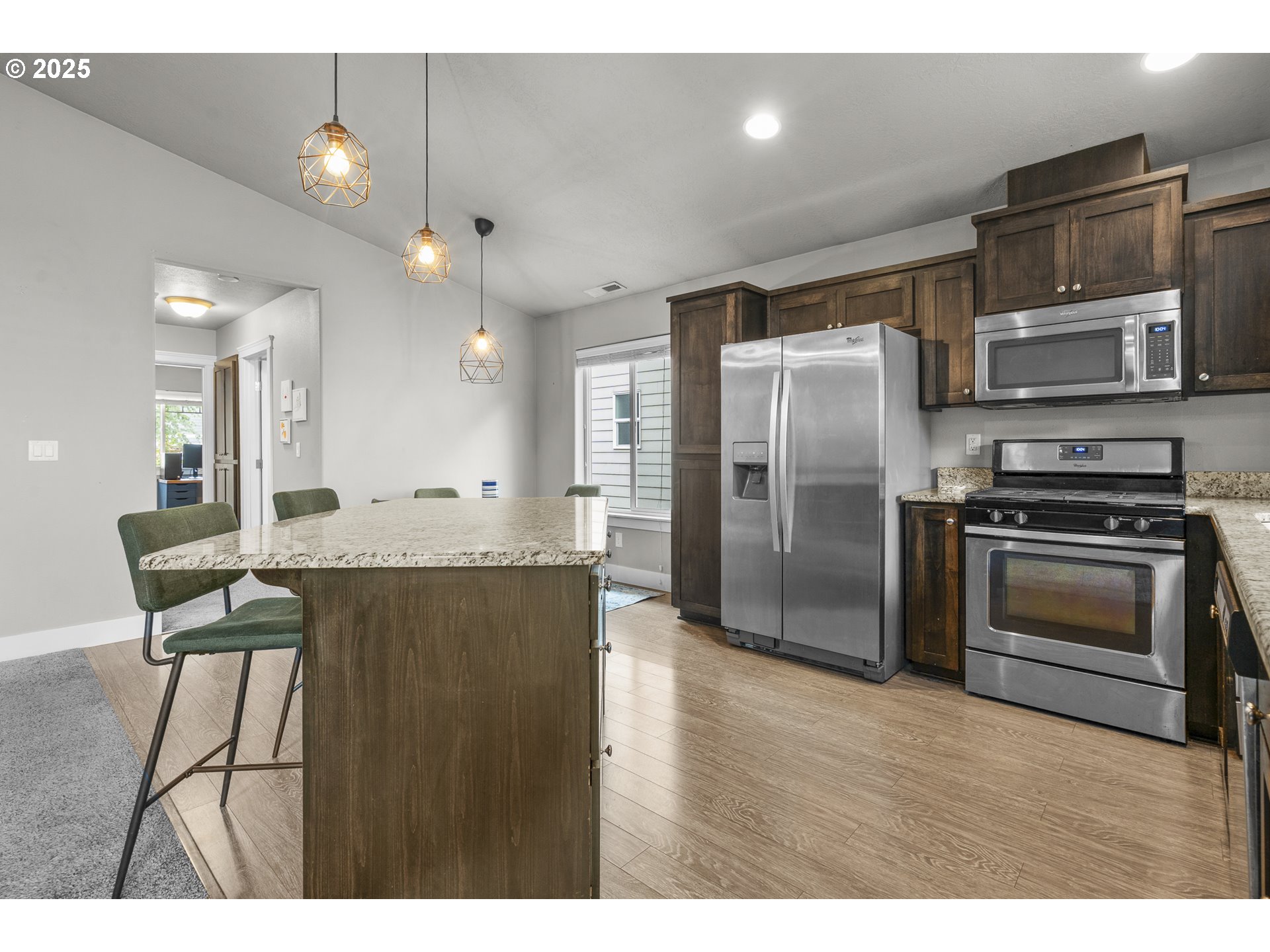 2474 Equestrian Loop South Salem, OR 97302 - Photo 4 of 23 a kitchen with stainless steel appliances granite countertop a stove a refrigerator and a microwave