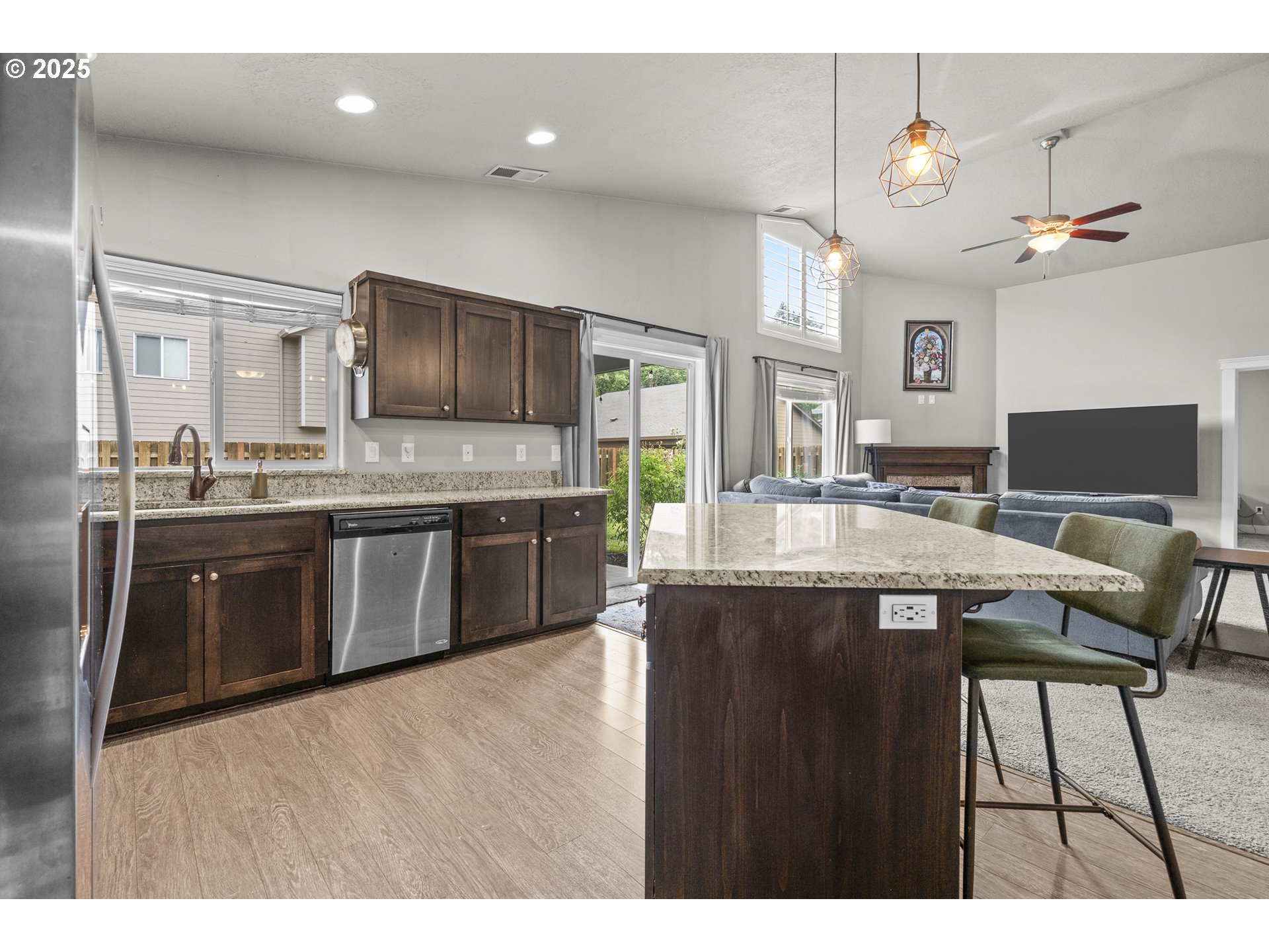 2474 Equestrian Loop South Salem, OR 97302 - Photo 5 of 23 a kitchen with cabinets a counter and chairs