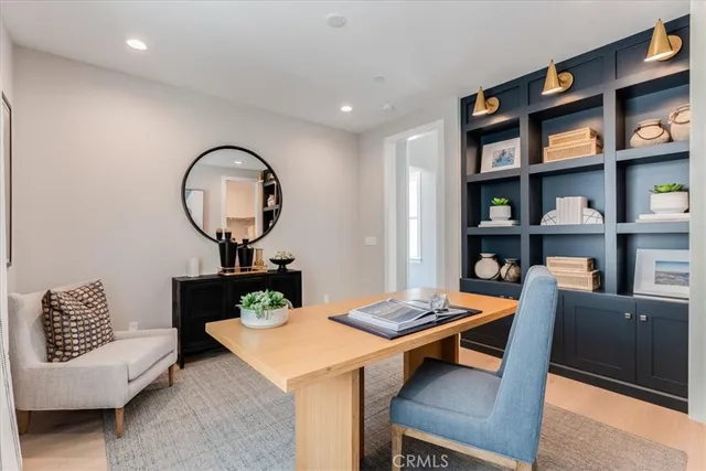 a living room with furniture and a book shelf