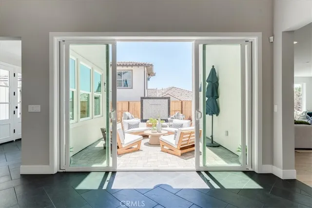 a living room with hardwood floor and a glass door