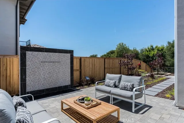 a backyard of a house with table and chairs