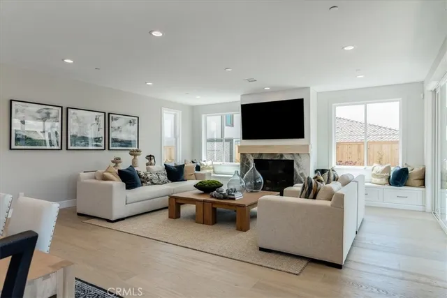a living room with fireplace furniture and a flat screen tv