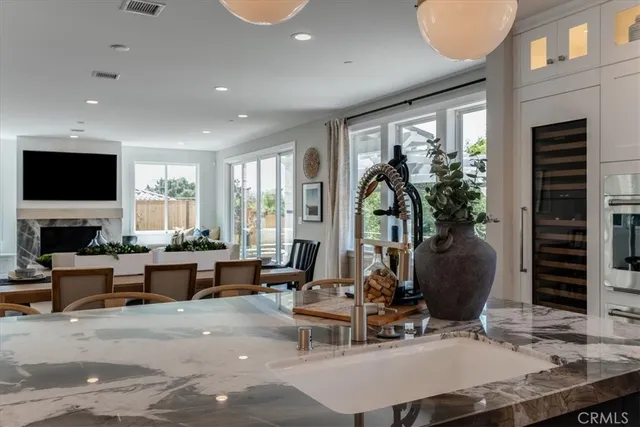 a living room with furniture a large window and a flat screen tv