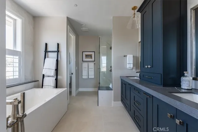 a spacious bathroom with a double vanity sink and a mirror