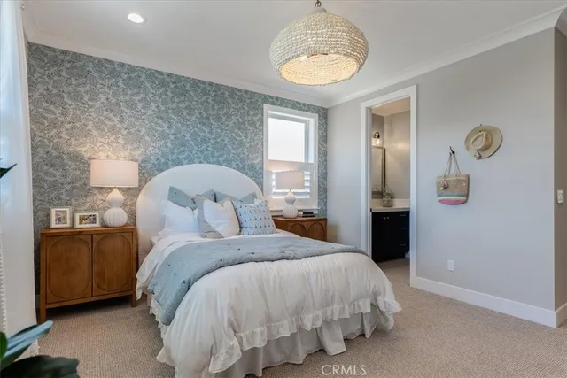 a bedroom with a bed and painting on the wall