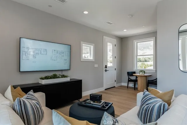 a spacious bedroom with a bed and a night stand